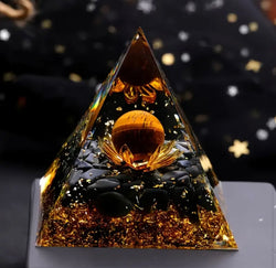 Black obsidian stone pyramid with Tiger’s eye stone ball